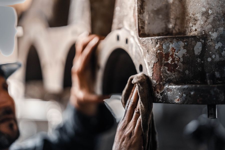 Technician maintaining industrial production equipment
